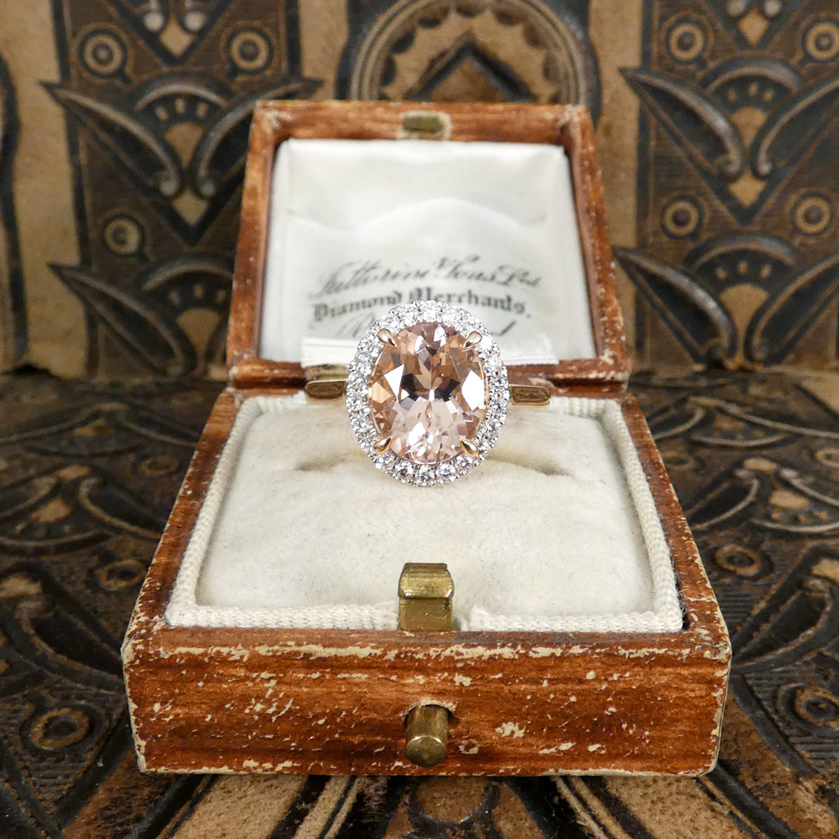 2.51ct Oval Cut Morganite and Diamond Halo cluster ring in 18ct White and Rose gold. The Morganite is showing a lovely peachy pink hue with a four spiked claw setting. Shown in vintage box making the perfect romantic gift.