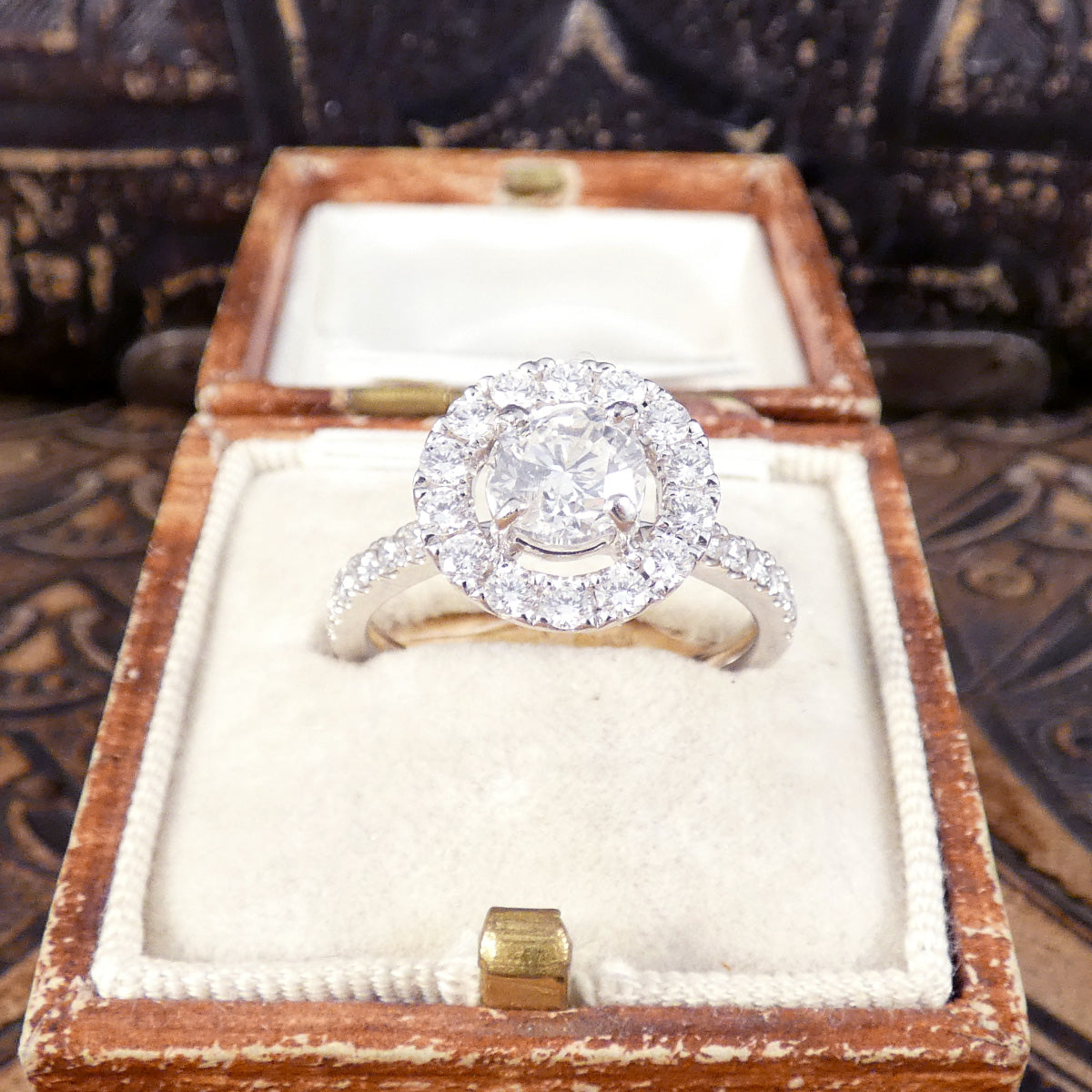 1.74ct Diamond Halo Engagement Ring with Diamond Set Shoulders in Platinum. Featuring a 1.00ct diamond round cut diamond centre with a surround of 0.74ct creating extra sparkle. Wedfit design making it the perfect engagement ring. Shown in vintage box.