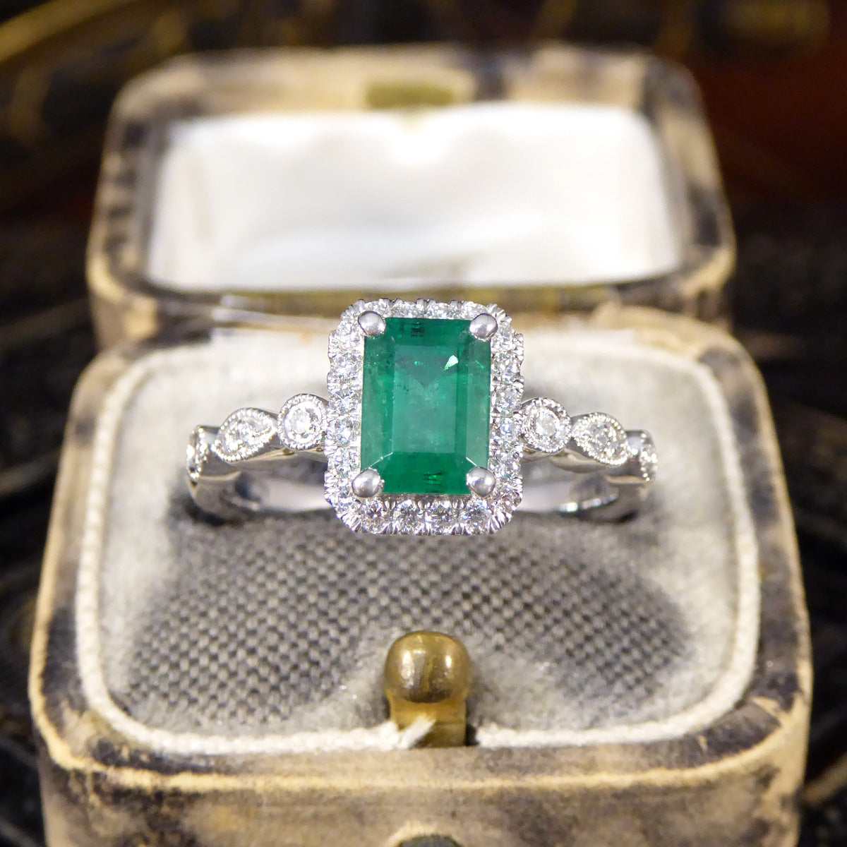 1.05ct Emerald and Diamond Cluster Ring with Diamond Adorned Shoulders in Platinum