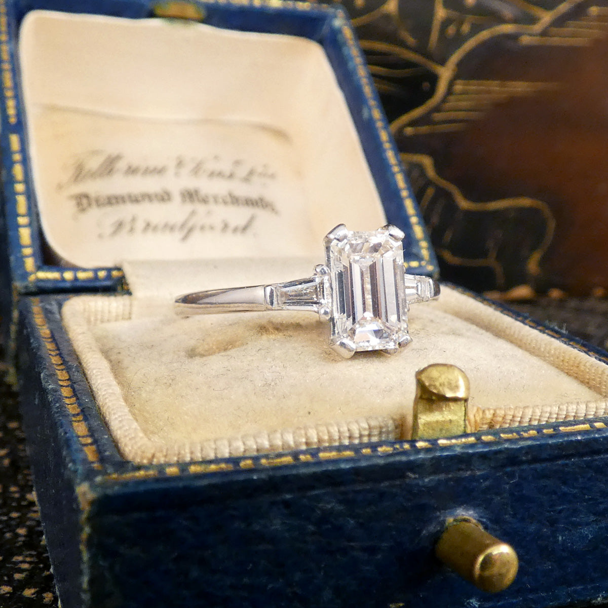 1.05ct Emerald Cut Diamond Engagement Ring with Tapered Baguette Shoulders in Platinum. The perfect give and timeless ring.