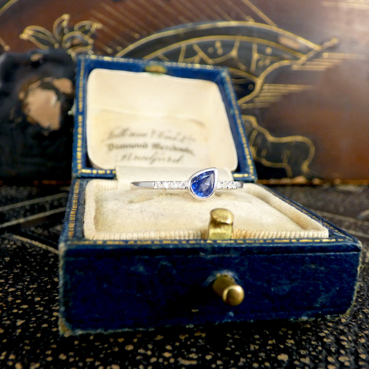 Sapphire and Diamond ring shown in a box, relaly seeing how much the colour pops.