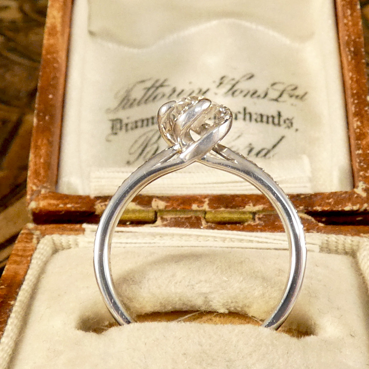 Side view of ring fully highlighting the twisted whimsical setting making it a unique and one of a kind engagement ring idea. 