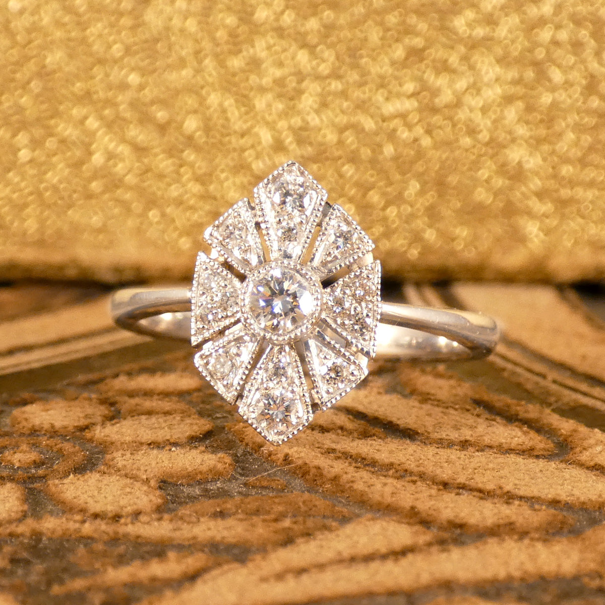 Art Deco-inspired replica ring crafted with exquisite craftsmanship in 18ct white gold, featuring intricate geometric patterns and a central diamond accent.